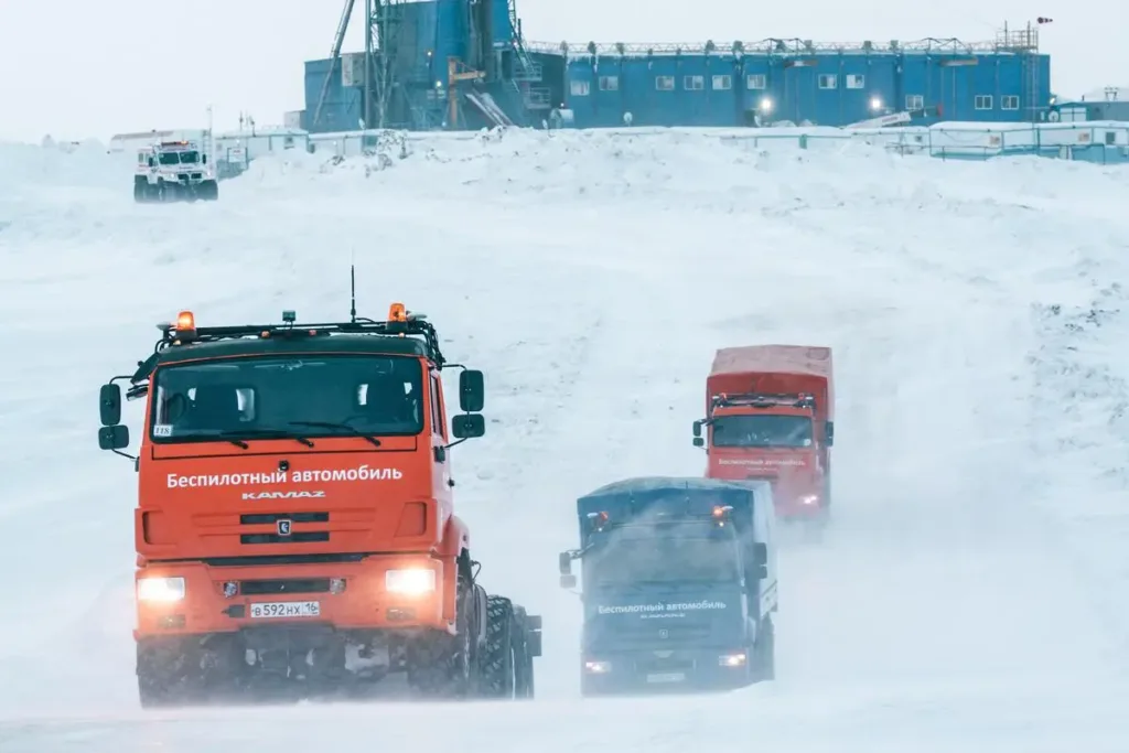 A convoy of Gazprom Neft unmanned trucks on an interfield road in Siberia.